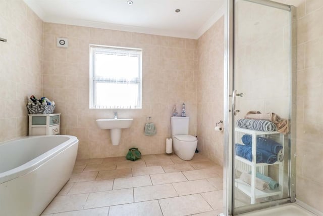 The huge family bathroom has a large bath and a double shower cubicle.