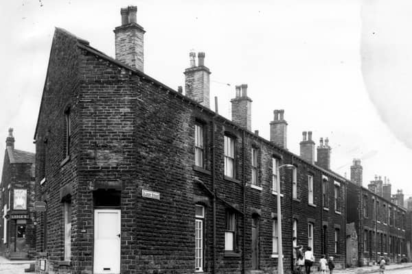 A long view of Albert Street taken from the junction with Stanningley Road in July 1968. Parents and children are gathered in the street outside number 5. A corner shop with a white door is numbered as 556 Stanningley Road and in the background left, is the corner shop, Lodges at the corner bottom of Waterhouse Terrace at number 560.