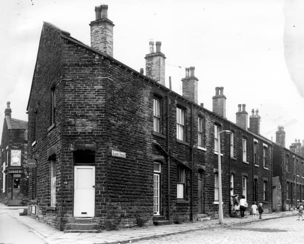 A long view of Albert Street taken from the junction with Stanningley Road in July 1968. Parents and children are gathered in the street outside number 5. A corner shop with a white door is numbered as 556 Stanningley Road and in the background left, is the corner shop, Lodges at the corner bottom of Waterhouse Terrace at number 560.