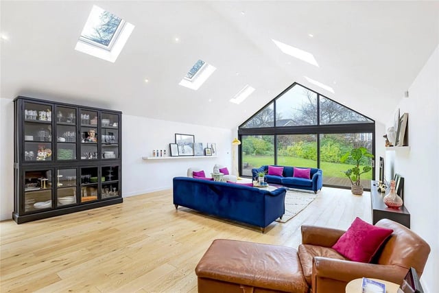 A charming reception space filled with an abundance of natural light via a range of sliding glazed doors overlooking the front garden. A large window to the side elevation and velux windows. High quality oak flooring and under floor heating.