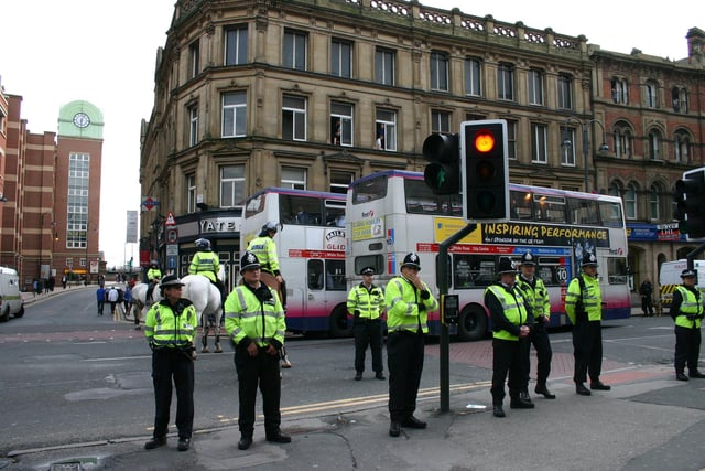 Leeds and Huddersfield fans clashed in Leeds city centre ahead of a Carling Cup game at Elland Road. The area was cordoned off by police who shipped the fans out on two double decker buses.  Some of the officers attending the scene were in riot gear in 2004.