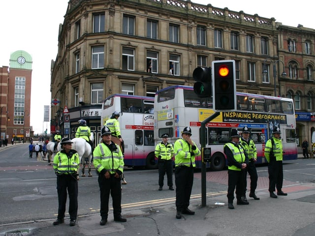 Leeds and Huddersfield fans clashed in Leeds city centre ahead of a Carling Cup game at Elland Road. The area was cordoned off by police who shipped the fans out on two double decker buses. Some of the officers attending the scene were in riot gear in 2004.