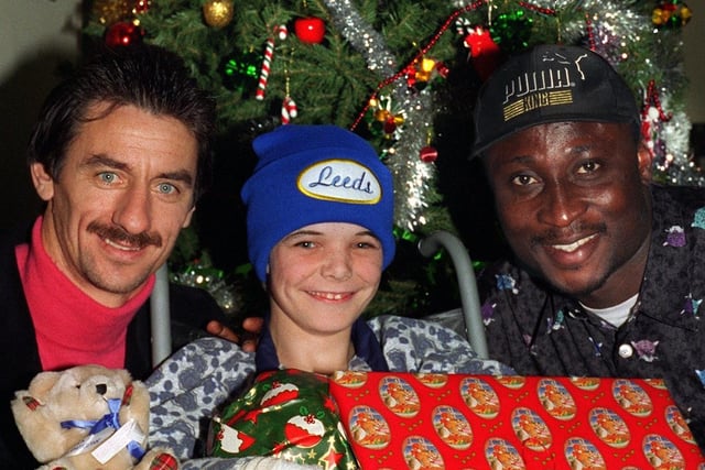 Leeds United stars Ian Rush and Tony Yeboah brought Christmas cheer to the youngsters on the children's ward at the Clarendon Wing of Leeds General Infirmary in December 1996 when  they paid a visit to the ward to give young patients presents . Pictured enjoying the occasion is Jason King.