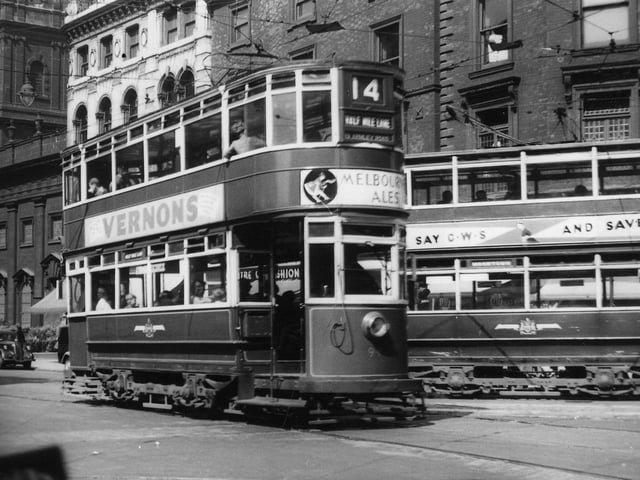 Two trams on Boar Lane in July 1951. In the foreground is tram no.99, which is on the no.14 route, Half Mile Lane via Armley Road.
