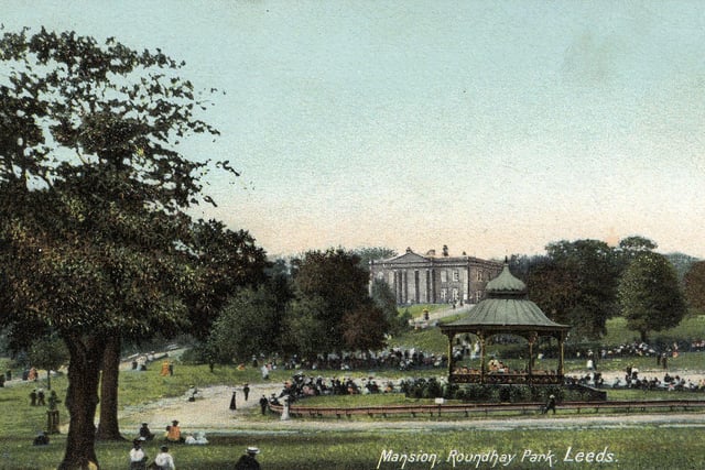 An undated colour-tinted postcard of Roundhay Park showing The Mansion and the bandstand in Roundhay Park.