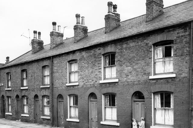 Cross Speedwell Street which also had frontage on Speedwell View in August 1965. Two children stand in the doorway of number 12. The Speedwell street names refer to a healing well or spa which had existed in this area at one time.