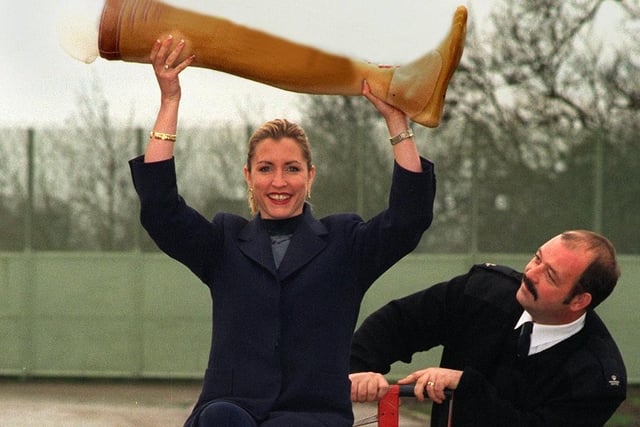 Model Heather Mills pictured with an artificial limb at Wetherby Young Offenders Institution in December 1997. She is watched by Prison Officer George Bryant.