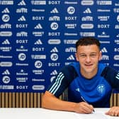NEW DEAL: Nineteen-year-old Leeds United defender Kris Moore puts pen to paper on a fresh two-year Whites contract.