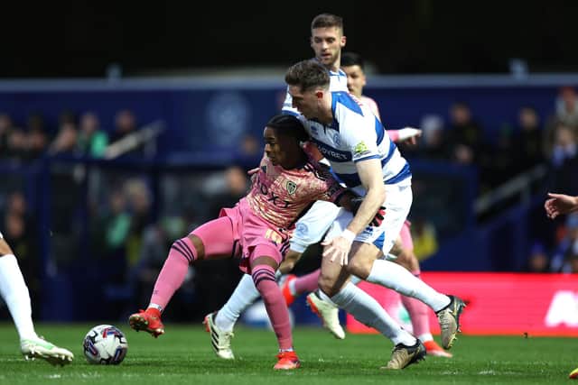 ANGER: Shown by Leeds United star Crysencio Summerville, left, pictured battling with QPR's Jimmy Dunne in Friday night's crushing 4-0 defeat at Championship hosts Queens Park Rangers. Photo by Steven Paston/PA Wire.