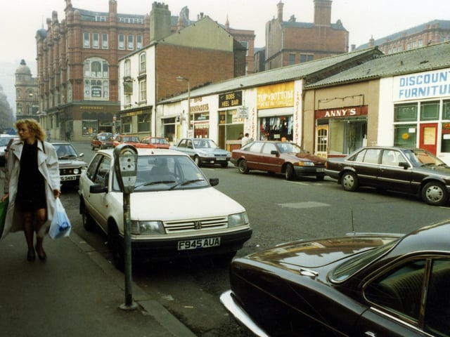 A view of George Street looking in the direction of Ludgate Hill and Vicar Lane in the 1980s The red brick building at the left edge had once housed the department store, Willis Ludlow's. The tall white rendered building is the Market Tavern of number 1 George Street, which stands at the junction with Harewood Street.