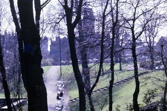A view from Scarth Gardens along both parts of Scatcherd Park in April 1962 - notice the dome of the Town Hall still missing after the fire of August 1961. The original Scatcherd Park stretched as far as the end of the park benches from the border on Queen's Promenade in the foreground. The section beyond the park benches is an addition to the original park of 1911 and was laid out between 1936 and 1939 in the area that had originally been the grounds of Morley House. This building and its grounds were bequeathed to Morley Town Council in the will of its last owner Mr. Richard Borrough Hopkins, Morley's first town clerk. Strictly speaking this extension to Scatcherd Park is correctly known as the Hopkins Gardens.