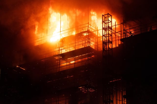 The fire service issued an initial statement at around 9.25pm when it said the top three floors of the building were still alight.