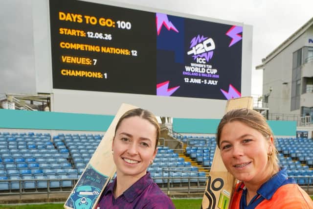 Rachel Slater and Sterre Kalis bats raised in front of Headingley Scoreboard with 100 Days to Go
