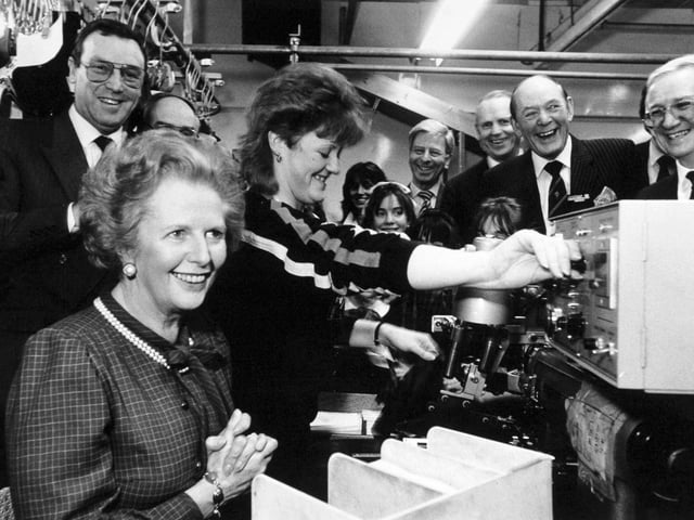 Margaret Thatcher was all smiles as she tried her talents at machining a pocket lining for a jacket during her visit to Centaur Clothes on Great George Street in February 1987. Karen Pheasby, 19, who normally works on the machine, shows how it's done. John Jackson, chairman and managing director of Centaur Clothes, is on the left.