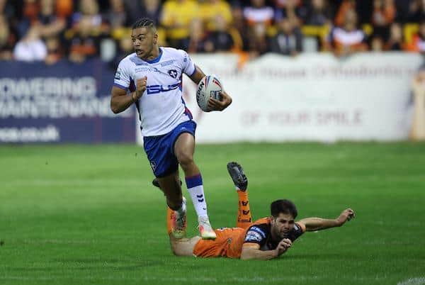 Trinity winger Lewis Murphy races away from Jake Mamo to score his second try. Picture by John Clifton/SWpix.com.
