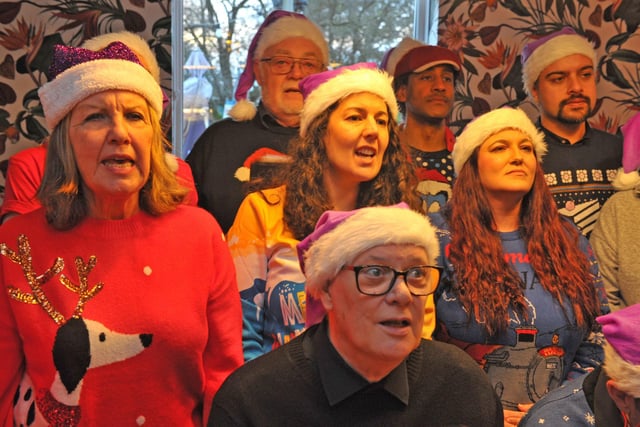 Members of the Vocologee choir helped brighten the mood at the Christmas wrap event.
