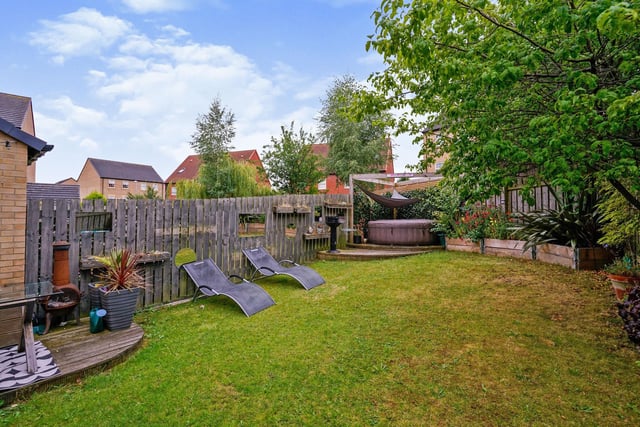 Outside is a driveway with off street parking and a garage, and the enclosed large rear garden has a great lawned space perfect for garden furniture, decking and plant borders.