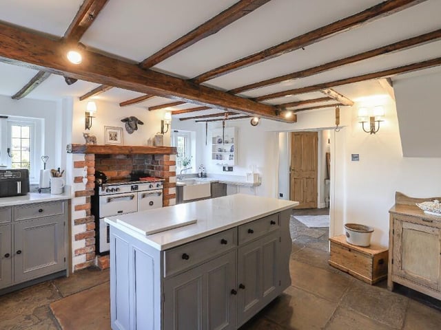 The kitchen offers excellent storage and preparation space, complemented by the characterful Yorkshire stone flooring and direct access to a practical utility area and ground-floor w.c.