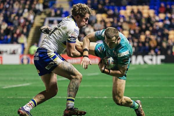 Leeds’ Ash Handley is tackled by Greg Minikin during Rhinos' defeat at Warrington. Picture by Alex Whitehead/SWpix.com.