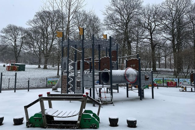 The children's playground, covered in snow, in Roundhay Park, Leeds.