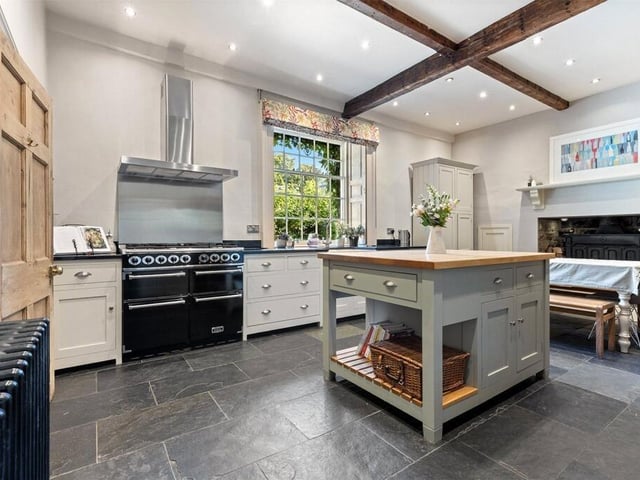 At the back of the house is a charming, open plan dining kitchen, with bespoke handmade shaker cabinetry, granite worktops and central island unit.