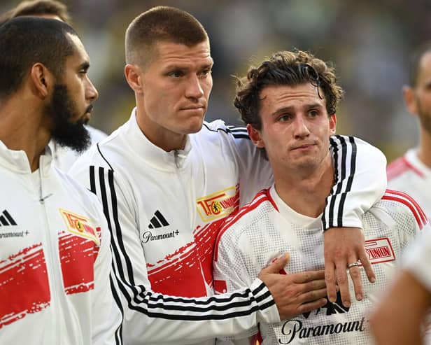 Players including including Union Berlin's German forward #17 Kevin Behrens (2nd L) and Union Berlin's US midfielder #07 Brenden Aaronson react after the German first division Bundesliga football match between Borussia Dortmund and 1 FC Union Berlin in Dortmund, western Germany on October 7, 2023 (Photo by INA FASSBENDER/AFP via Getty Images)