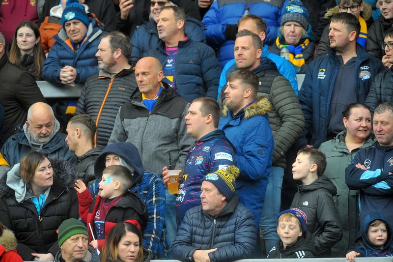 A big crowd braved torrential rain and bitter cold to watch Leeds Rhinos overcome French visitors Catalans Dragons.
