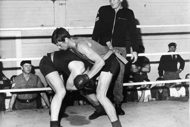 Sergeant Richard Dunn, a parachute regiment contender for the British heavyweight boxing championship, supervises a bout in the ring at Pudsey in September 1975. He beat Bunny Johnson on points over 15 rounds to win the British and Commonwealth heavyweight titles. He unsuccessfully challenged Muhammad Ali for the World Heavyweight title in 1976.