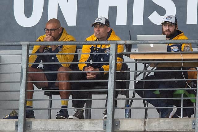 Leeds Rhinos coach Rohan Smith, centre, watches as his side slump to an 18-10 loss at Hull FC, flanked by Chev Walker, left and analyst Adam Cunliffe. Picture by Bruce Rollinson.