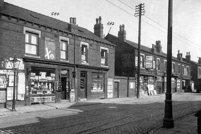 Shops along Compton Road in September 1935. Pictured, from left, are W H Binks, hairdresser and newsagents, Compton Fisheries, A Pullan, Confectioners, Ramsden, dental surgeon, and Beck's bakery. Poster for Shaftesbury cinema, which was showing 'Vagabond Lady', 'Masa Hiruwaka', and 'One Frightened Night'. R