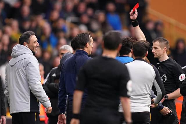 Referee Michael Salisbury shows a red card to substitute Wolverhampton Wanderers' Matheus Nunes (hidden) during the Premier League match at Molineux Stadium, Wolverhampton. Picture date: Saturday March 18, 2023. (Picture credit: Mike Egerton/PA)