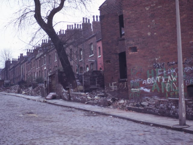 A row of derelict terraced housing on Greenmount Place taken in May 1973 shortly before demolition. Outbuildings in front have already been pulled down leaving bricks and rubble in the yards.