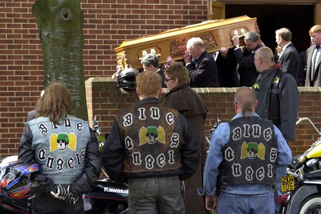 Members of the Blue Angels watch as the coffin  of their friend and fellow Blue Angel Stephen Mooney is carried out of  St Theresa's Church in Cross Gates in May 2000.