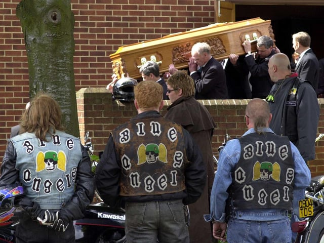 Members of the Blue Angels watch as the coffin  of their friend and fellow Blue Angel Stephen Mooney is carried out of  St Theresa's Church in Cross Gates in May 2000.