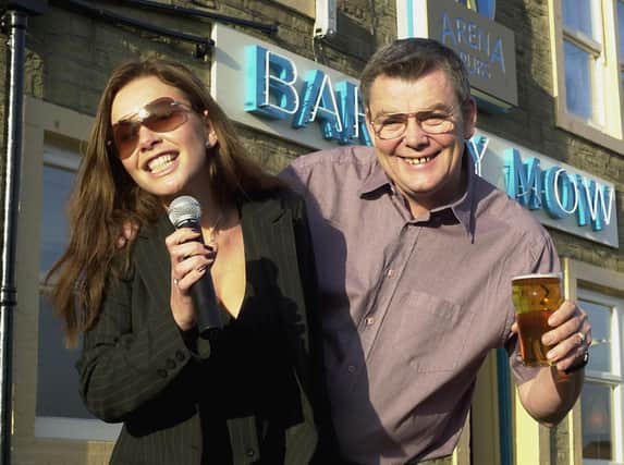 Victoria Beckham look-a-like Gill Penny is pictured with landlord Jim Meecham at the Barley Mow pub on Town Street in November 2002.