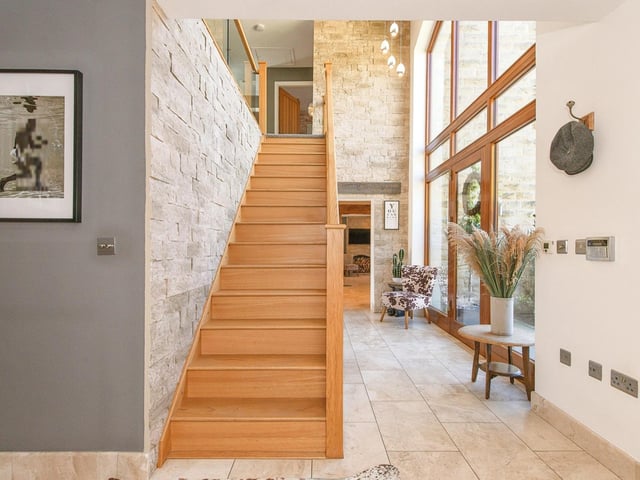 The entrance hallway benefits from natural light pouring in through the arched feature window.