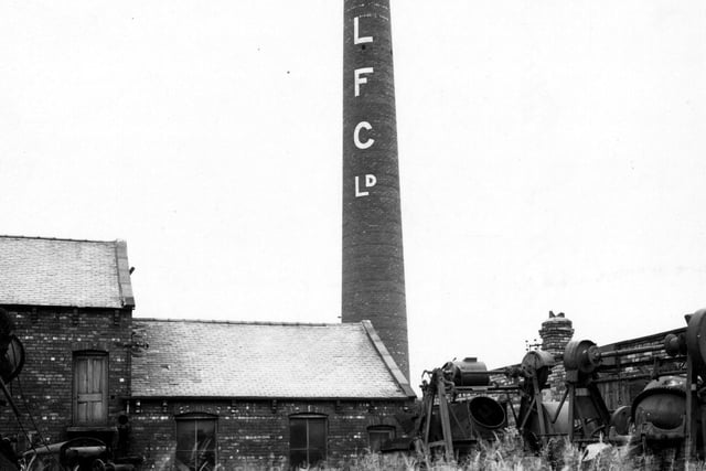 The site of Leeds Fireclay Co Ltd, fireclay goods manufacturer, at Wortley Moor Road. Main feature is a tall chimney with letters LFC LD painted down its length. There are large peices of machinery standing in area of tall grassland. Pictured in July 1945.