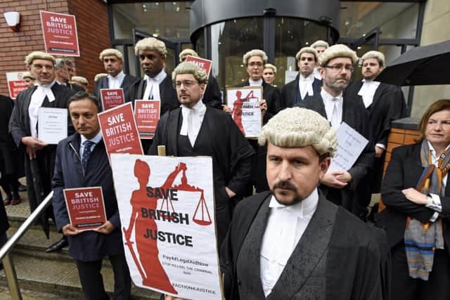 Barristers outside Leeds Crown Court during a recent strike day. They have started an indefinite strike this morning, meaning they will not go back to work until the issue is resolved. Picture: Asadour Guzelian