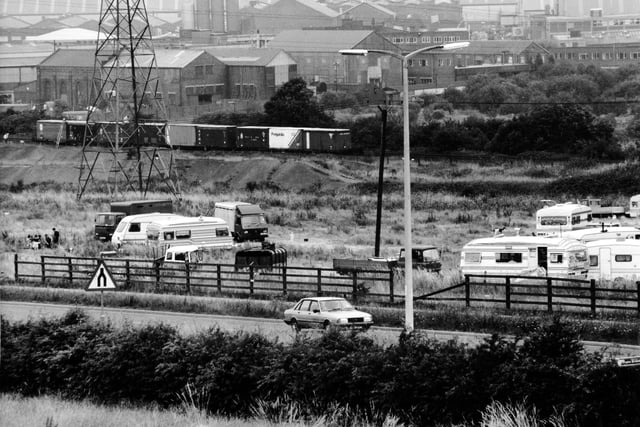 Caravans and trailers from the gypsy and traveller community at Stourton in August 1991. The roadside site was located near railway wagons containing chemicals.