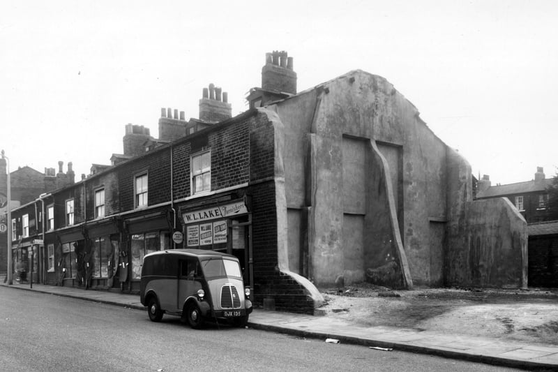 Woodhouse Street in September 1959. On the left is the junction with Delph Lane, then 200, 198 is the business of Arthur Naylor, a grocers and off-license. The next three shops, 192 to 196 are one unit. The name Jones is over the shop which is selling curtains and carpets. At the right side, no.190 is W.I. Lake, furniture dealer. Next, cleared area.