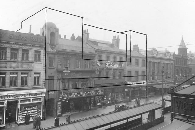 Shops on Briggate in March 1938. Outline around central block of buildings where Marks and Spencers will be built. Pictured, from left to right, can be seen, Lyons and Co, Bull and Bell Yard and Rialto Cinema.