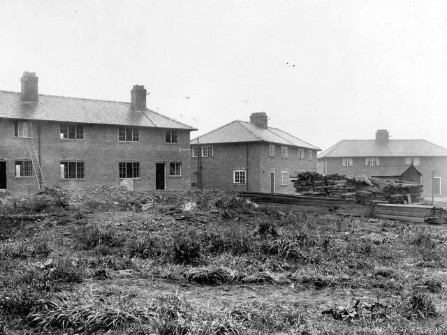 Picture shows the developments to the Wyther Housing Estate. Semi detached houses line the background. Piles of planks are visible to the right. A ladder can be seen leaning up to a window on the left. Pictured in September 1920.