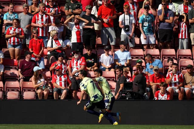 OUT OF JAIL: Goalscorer Rodrigo, centre, and team mate Brenden Aaronson, left, celebrate as Leeds United go 1-0 up at St Mary's as Southampton's fans look on but despite going a further strike behind the home faithful were left toasting a point. Photo by Eddie Keogh/Getty Images.