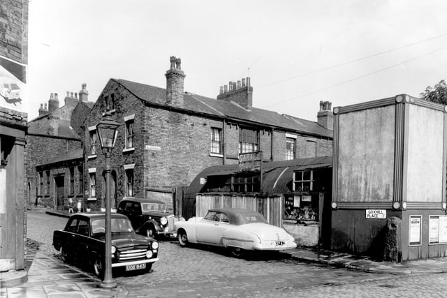 This is Goxhill Place, seen from Buslingthorpe Lane, part of Goxhill Place backed onto St. Michael's Square. The houses had been built with gaps between which gave access to the Square. On the left, the single storey building is across one of these gaps. Pictured in July 1958.