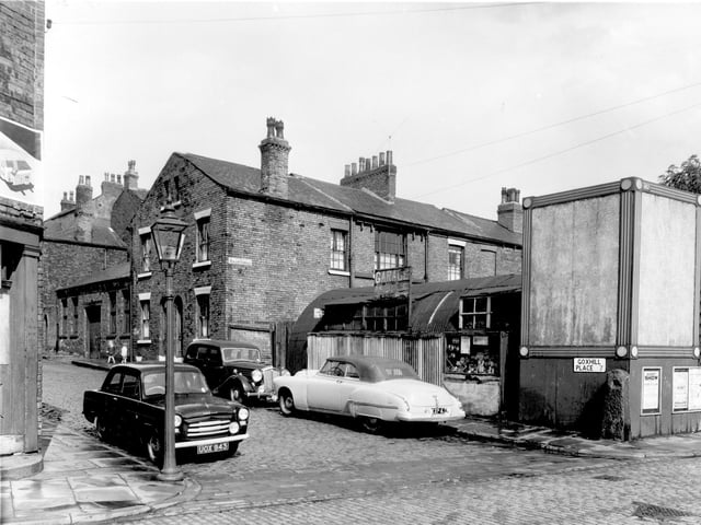 This is Goxhill Place, seen from Buslingthorpe Lane, part of Goxhill Place backed onto St. Michael's Square. The houses had been built with gaps between which gave access to the Square. On the left, the single storey building is across one of these gaps. Pictured in July 1958.