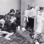 Young mum Wendy Thorne cuddles her eight week old son at a squatter home near Armley Jail in November 1984 as a Home Office official knocked on the front door, The official had come from London to ask the squatters to leave Home Office property after the residents of Elsworth Street demanded their eviction - but they refused.
