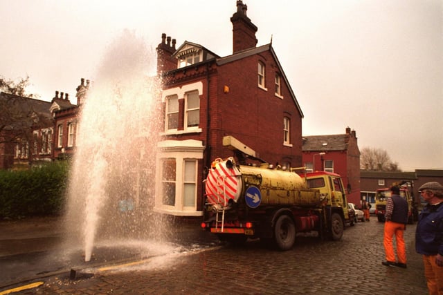 A gushing broken water pipe at the junction of Clarendon Road and Kendal Road in December 1995.