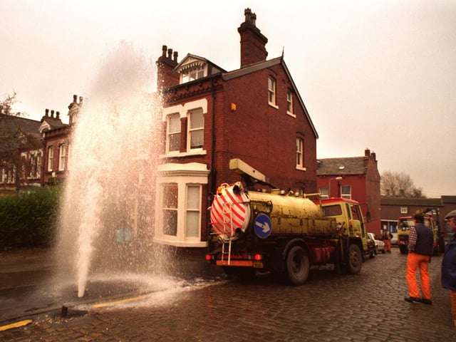 A gushing broken water pipe at the junction of Clarendon Road and Kendal Road in December 1995.