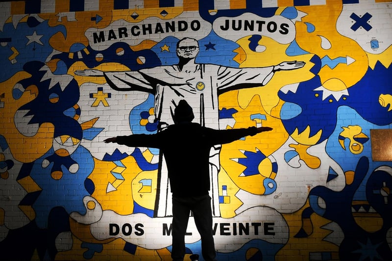 End of an era. A Leeds United Fan is pictured by the Marcelo Bielsa mural in February 2022
