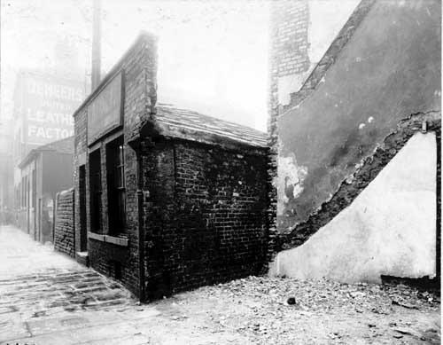 In the centre, number 12 Neville Street, premises of C.D. Fidgett cigar and tobacco manufacturer. The adjoining property, which had been number 13, Yorkshire Limewashing and Colouring Co. has been demolished. this building was to one side of the entrance to Francis Court. Pictured in October 1910.
